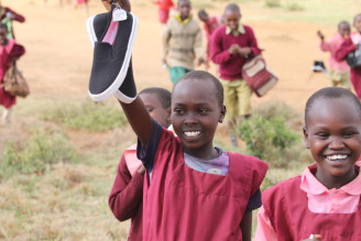 Christel Nani Adventures in Africa, "Safari and Shoes." Volunteers visited a school bringing much needed sneakers and art supplies and went game driving with world class guide, Jackson Looseyia, from the hit show, "Big Cat Diaries".